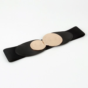 Detail of black elastic belt featuring two gold circular metal buckles with radial texture