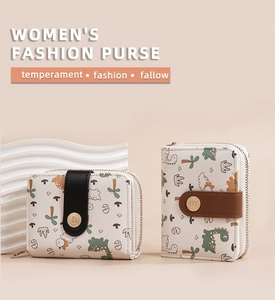Detail of short women's wallets with cute dinosaur prints and zip buckle closures