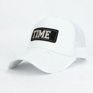 Detailed view of the distressed brim and TIME embroidery on a white mesh trucker hat