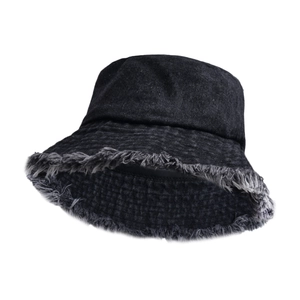 Detailed close-up of a black denim bucket hat featuring raw frayed edges and denim texture