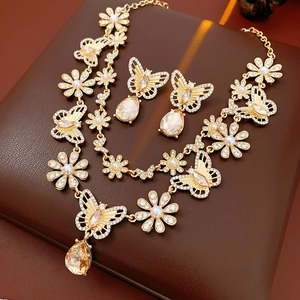 Detail of vintage gold jewelry set with champagne stones and pearls on brown leather box