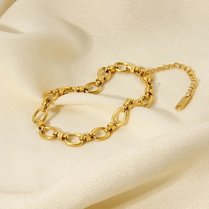 Detail of 18K gold-plated oval chain link bracelet on soft champagne silk background
