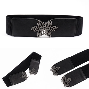 Detail of black elastic cinch belt featuring a decorative metal leaf buckle design