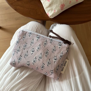 Detail of floral zipper coin purse in lavender cotton with simple wish woven label