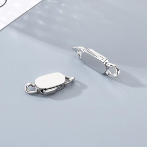 Macro shot of two polished silver stainless steel oval lobster clasps for jewelry making