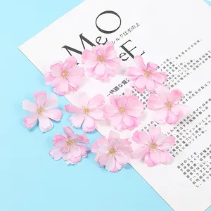 Detailed macro view of artificial light pink plum blossoms for DIY hair accessories