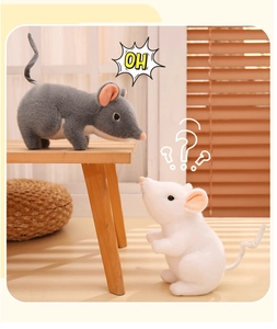 Close-up of cute grey and white plush mice toys with soft texture on wooden background