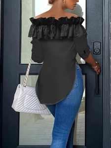 Rear view of black off-the-shoulder ruffle top paired with blue jeans and white bag