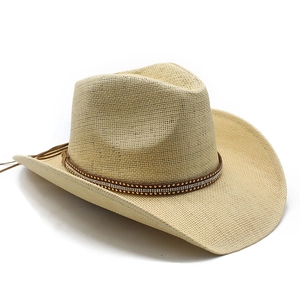 Close-up of woven straw cowboy hat with beaded leather band and fine texture details