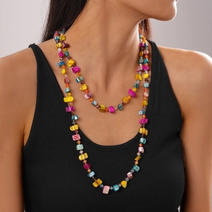Detail of colorful irregular beaded necklace in multi-layered bohemian style for women