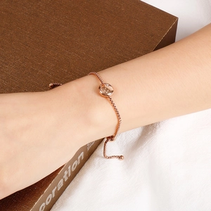 Close-up of Gemini constellation charm on rose gold adjustable chain bracelet