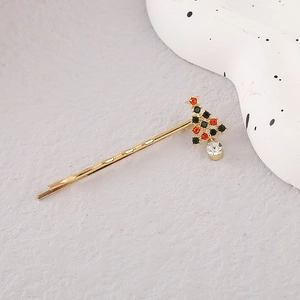 Elegant gold Christmas tree hair clip with red and green rhinestones and a star top