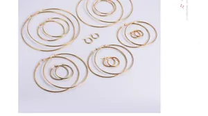 Detailed overhead view of multiple sizes of gold plated stainless steel hoop earrings