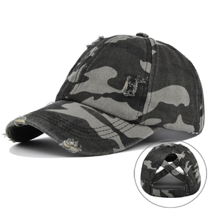 Detail of grey camouflage ponytail baseball cap showing distressed fabric and elastic back