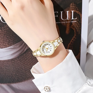 Elegant gold and white quartz watch for women featuring a round dial and metal bracelet