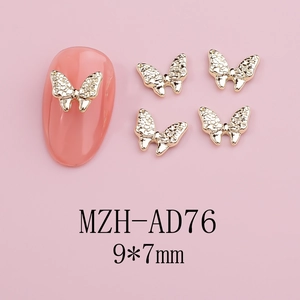 Detailed view of golden metal butterfly nail charms with rhinestones sized 9x7mm