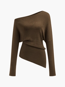 Detail of the brown off-shoulder knit sweater showing irregular asymmetric hem and fine texture