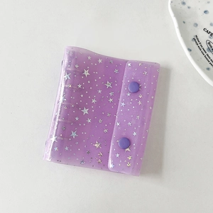 Detail of purple glitter PVC mini binder with stars and double snap button closure