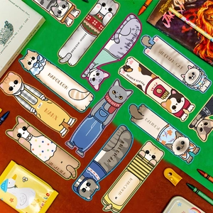 Flat lay of colorful assorted cat bookmarks with different breeds on a desk setup