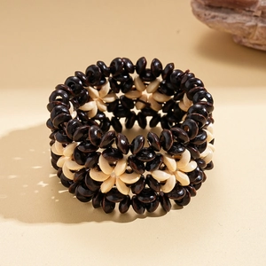 Detailed weave of brown and beige coconut wood beads in a vintage ethnic bracelet style