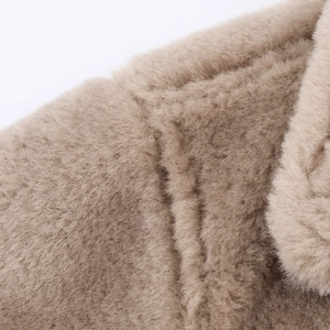 Close-up of the plush texture and camel lamb wool fabric on this warm reversible jacket