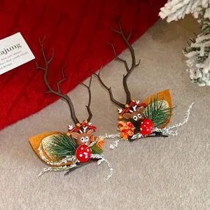 Detail of Christmas reindeer antler hair clips with pine needles and mushroom accents