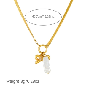 Gold plated stainless steel necklace with bow, crystal, and baroque pearl pendant