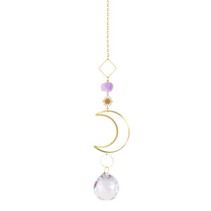 Detail of amethyst raw stone pendant with gold chain sun crescent moon and crystal ball