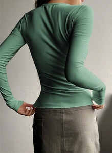 Close-up of the green ribbed knit sweater back showing slim fit tailoring and texture