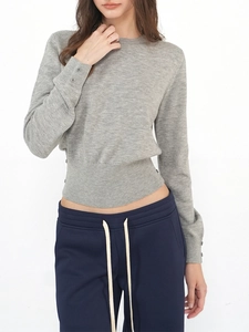 Detailed view of grey wool knit top with waist-cinching cut and decorative cuff buttons