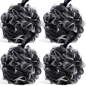 Set of four large black bamboo charcoal bath loofahs with hanging loops on white background