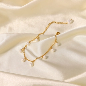 Elegant 18K gold-plated anklet with white shell pearls and tassel charms on satin