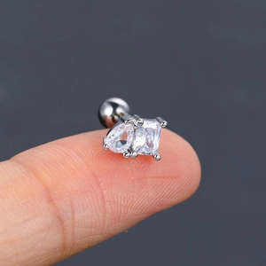 Macro shot of silver stud earring with pear and square cubic zirconia and screw back ball