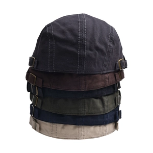 Detail showing adjustable metal buckles on vintage canvas flat caps in multiple colors
