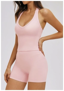 Pink yoga set detail showing high-waist shorts and V-neck racerback sports top texture