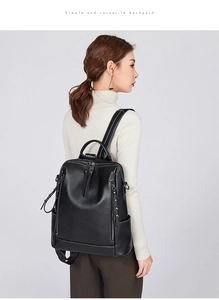 Side view of a black soft leather backpack for women with stylish white stitching details
