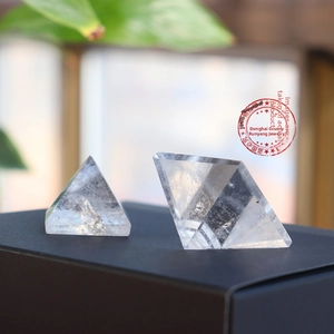 Macro detail of natural clear crystal pyramid and geometric polyhedral stone ornaments