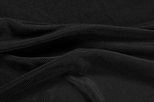 Detail of the high-quality black ribbed knit fabric with vertical texture and soft drape