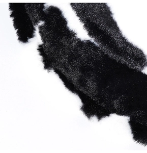 Macro shot showing soft black and white cow print faux fur texture of the warm bucket hat