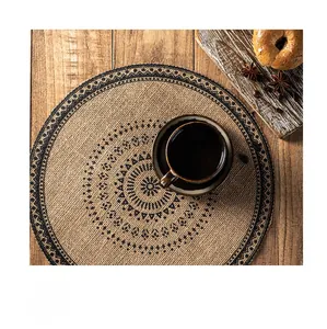 Detailed close-up of a rustic woven jute placemat with ethnic brown patterns and fringe