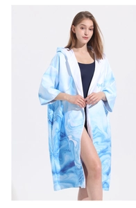 Detail of hooded beach towel with blue marble print, zipper closure and quick-dry fabric