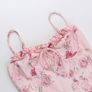 Detalle del vestido con estampado de rosas rosas con escote de volantes y lazo en la parte frontal