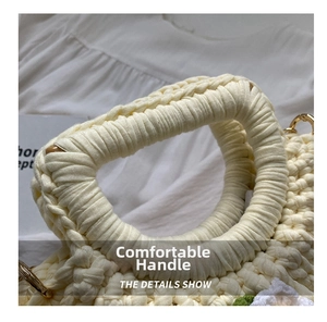 Detail of hand-woven off-white shell bag handle with durable golden metal ring buckle
