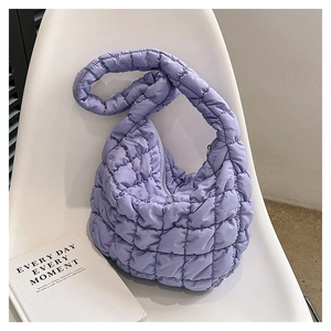 Detailed close-up of a purple quilted hobo bag featuring soft cloud-like puff texture