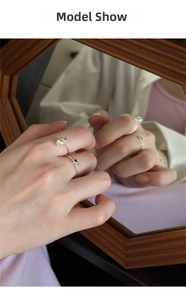 Detail of 925 sterling silver ring set with pearl and black heart on model hand