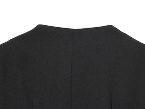 Close-up of fine woven fabric texture and stitching details on a black blazer dress