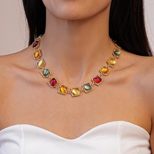 Close-up of vintage resin necklace with colorful square and oval gemstone pendants