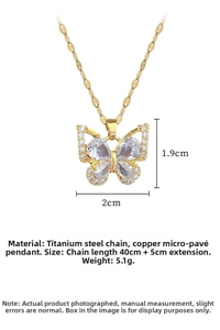 Detailed view of gold butterfly pendant with size labels 2cm by 1.9cm on titanium chain