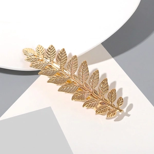 Detailed close-up of golden metal leaf headband showing intricate vein textures and finish
