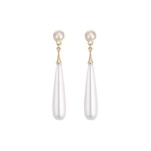 Detailed macro view of S925 silver vintage gold drop earrings with white baroque pearls